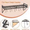 Space-saving metal wall rack holding pots, pans, and cooking spoons