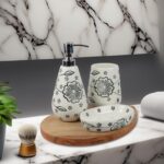 White ceramic soap dispenser, tray, and toothbrush holder arranged neatly on a bathroom counter