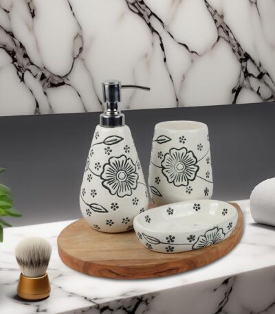 White ceramic soap dispenser, tray, and toothbrush holder arranged neatly on a bathroom counter