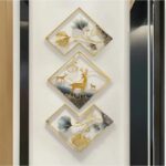 Metal deer wall art set hanging on living room wall