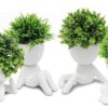 Four artificial succulent plants in cute ceramic human-shaped pots for home decoration.