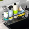 Metal sponge holder placed near faucet for easy dishwashing access.