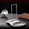 Lid and utensil rest stand made of stainless steel