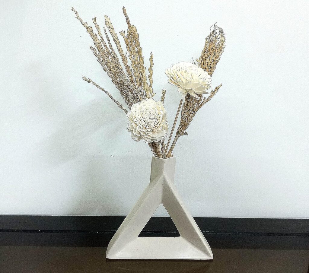 Stylish ceramic triangle flower vase with artificial floral arrangement