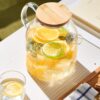 Elegant glass pitcher with natural wooden lid for serving drinks