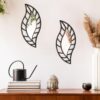 Hand-carved wooden wall mirror featuring a stylish leaf motif