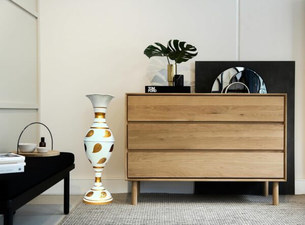 Metal decorative vase showcasing painted leaf artwork for home styling