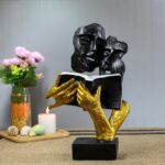 Romantic abstract couple reading book statue in black and gold resin
