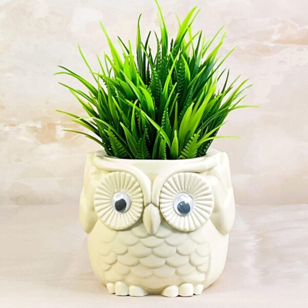 Decorative artificial fern plant in owl pot for office desk