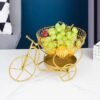 Stylish metal bicycle fruit holder displayed on a tabletop
