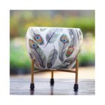 Elegant ceramic planter with golden metal stand and peacock feather design