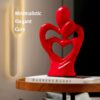 Elegant heart motif ceramic sculpture of hugging lovers