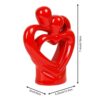 Beautiful romantic sculpture of hugging couple with heart stand