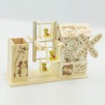 Wooden pen holder with multiple compartments and hanging teddy ornament