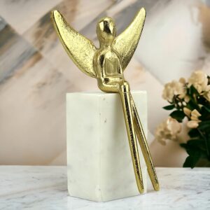 Handcrafted aluminum angel sitting on marble rock sculpture for elegant home decor