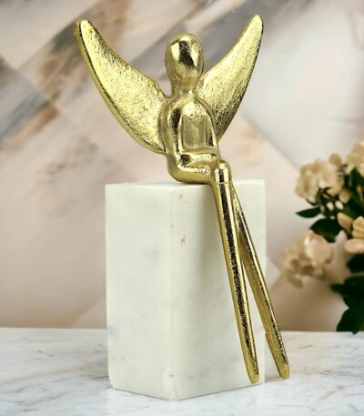 Handcrafted aluminum angel sitting on marble rock sculpture for elegant home decor