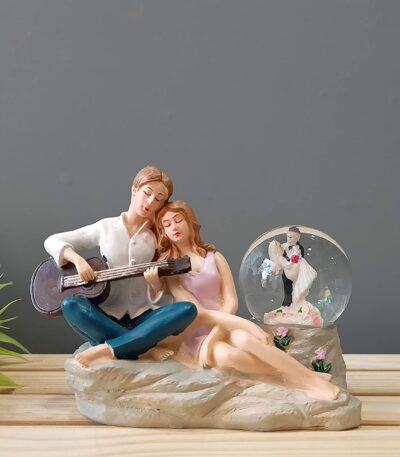 Love couple figurine enclosed in crystal glass ball showpiece